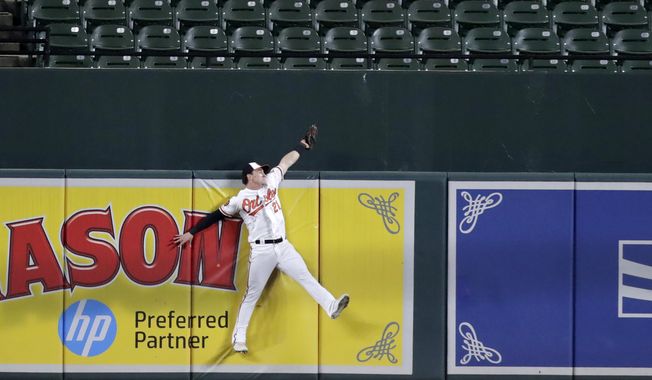Baltimore Orioles center fielder Austin Hays makes the catch at the wall on a ball hit by Toronto Blue Jays&#x27; Vladimir Guerrero Jr. during the fourth inning of a baseball game Thursday, Sept. 19, 2019, in Baltimore. (AP Photo/Julio Cortez)