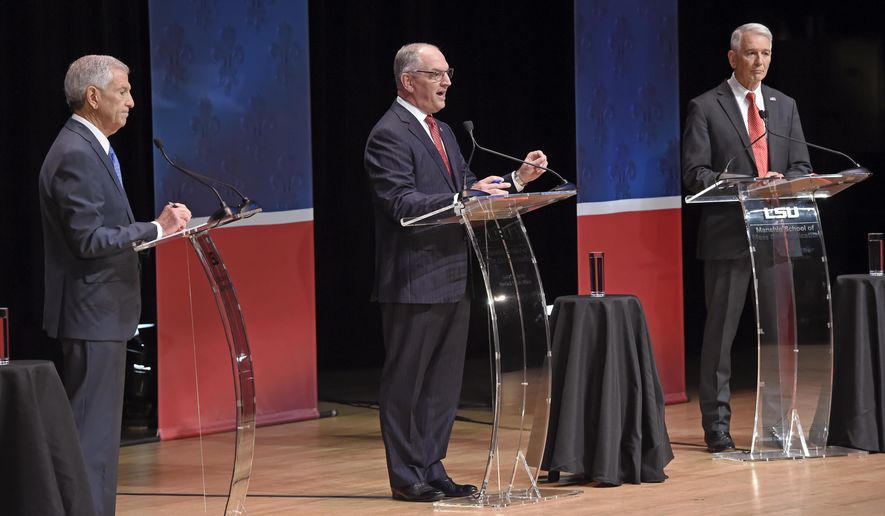 From left, Eddie Rispone, Gov. John Bel Edwards and Republican Rep. Ralph Abraham participate in the first televised gubernatorial debate Thursday Sept. 19, 2019, in Baton Rouge, La. (Bill Feig/The Advocate via AP, Pool)