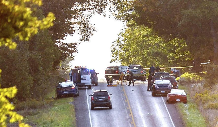 Police work the scene of a crash involving an Amish buggy on Wednesday, Sept. 18, 2019, in Chester Township in Eaton County. Eaton County Undersheriff Jeff Cook says the buggy was struck from behind Wednesday as it traveled along Vermontville Highway near Charlotte in southern Michigan. (Nick King/Lansing State Journal via AP)