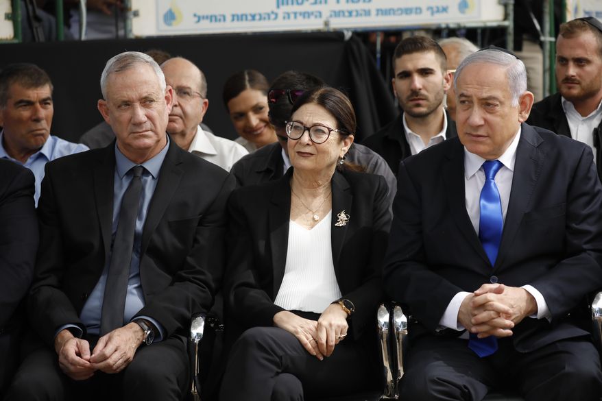 Blue and White party leader Benny Gantz, left, Esther Hayut, the Chief Justice of the Supreme Court of Israel, and Prime Minister Benjamin Netanyahu attend a memorial service for former President Shimon Peres in Jerusalem, Thursday, Sept. 19, 2019. Israelis are contending with the prospect of a third election, two days after an unprecedented repeat election left the country's two main political parties deadlocked, with neither Prime Minister Benjamin Netanyahu nor his rivals holding a clear path to a coalition government. (AP Photo/Ariel Schalit)