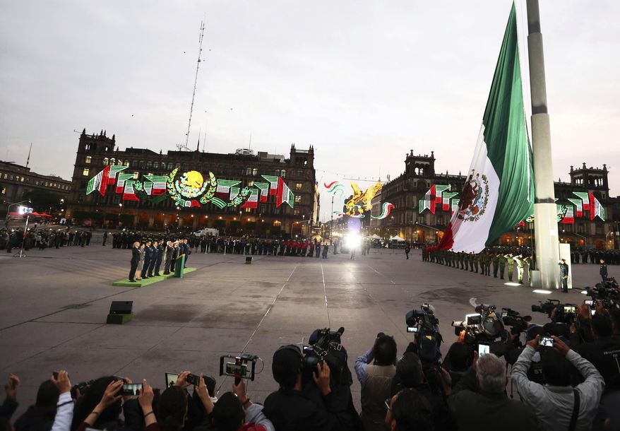 Mexico's President Andres Manuel Lopez Obrador leads a ceremony marking the 34th anniversary of the 1985 earthquake, in Mexico City, Thursday, Sept. 19, 2019. The 8.1-magnitude earthquake killed as many as 10,000 and left thousands homeless. The date also commemorates the 2017 earthquake that rattled the city killing hundreds. (AP Photo/Marco Ugarte)