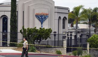 FILE - In this Sunday, April 28, 2019 file photo, a San Diego county sheriff&#39;s deputy stands in front of the Poway Chabad Synagogue in Poway, Calif. Prosecutors say John T. Earnest opened fire during a Passover service at the synagogue on April 27, killing one woman and injuring three people, including the rabbi. A preliminary hearing for Earnest begins Thursday, Sept. 18, 2019, in state court and is expected to last up to two days. (AP Photo/Denis Poroy, File)