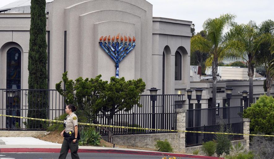 FILE - In this Sunday, April 28, 2019 file photo, a San Diego county sheriff&#x27;s deputy stands in front of the Poway Chabad Synagogue in Poway, Calif. Prosecutors say John T. Earnest opened fire during a Passover service at the synagogue on April 27, killing one woman and injuring three people, including the rabbi. A preliminary hearing for Earnest begins Thursday, Sept. 18, 2019, in state court and is expected to last up to two days. (AP Photo/Denis Poroy, File)