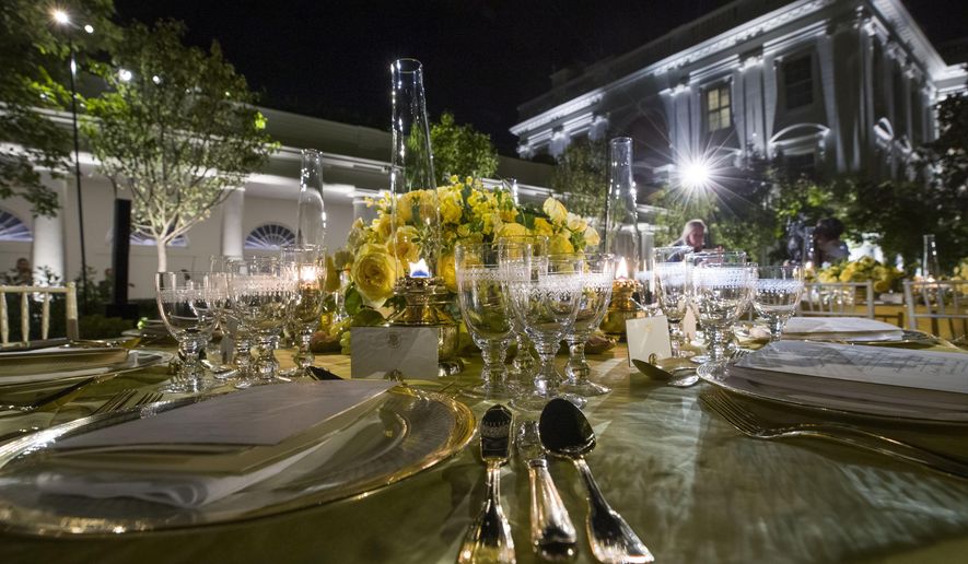A table is set during a media preview for the State Dinner with President Donald Trump and Australian Prime Minister Scott Morrison in the Rose Garden of the White House, Thursday, Sept. 19, 2019, in Washington. (AP Photo/Alex Brandon)