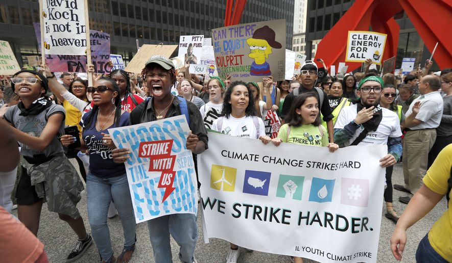 Protesters rally on the Federal Plaza inside Chicago's famed Loop during a global climate change march Friday, Sept. 20, 2019, in Chicago. Throughout the world Friday, young people banded together to demand that world leaders headed to a United Nations summit in New York step up their efforts to combat climate change. (AP Photo/Charles Rex Arbogast) **FILE**