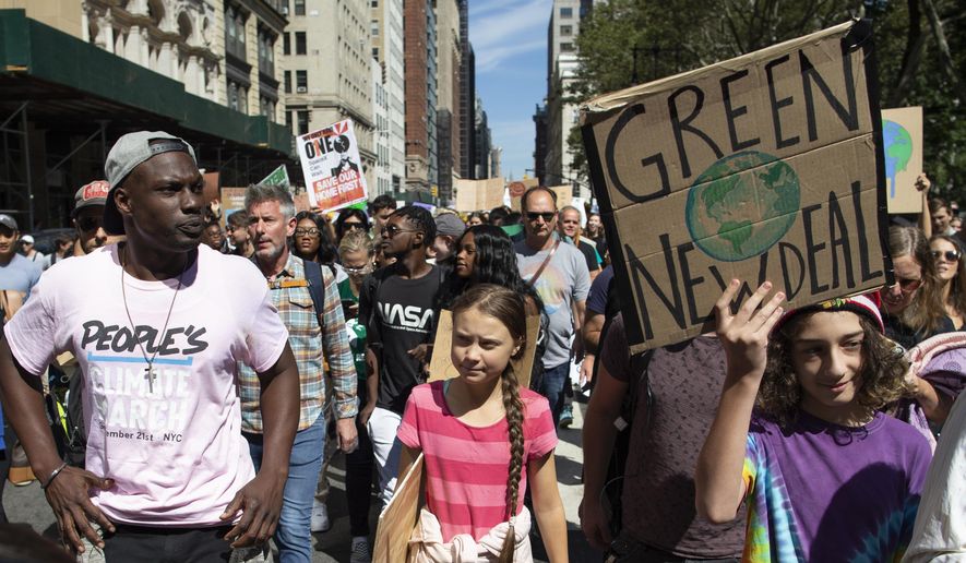 Swedish environmental activist Greta Thunberg, center, takes part during the Climate Strike, Friday, Sept. 20, 2019 in New York.  Rallies calling for action on climate change are happening in cities around the world Friday ahead of a summit on the issue.  (AP Photo/Eduardo Munoz Alvarez)