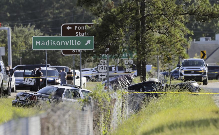 Two Mandeville police officers were shot after a vehicle chase, one fatally, near the U.S. 190 and Louisiana Highway 22 exit in Mandeville, La., Friday, Sept. 20, 2019. Mandeville Police Chief Gerald Sticker says one officer was killed and the other was wounded Friday but expected to survive the shooting in that community on the north shore of Lake Pontchartrain. Two suspects are in custody. (David Grunfeld/The Advocate via AP)
