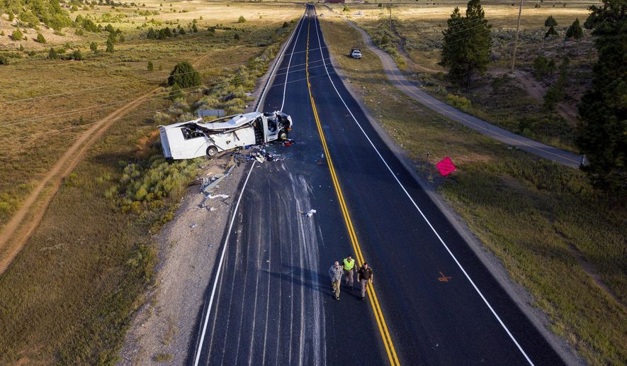 The remains of a bus that crashed while carrying Chinese-speaking tourists lie along State Route 12 near Bryce Canyon National Park, Friday, Sept. 20, 2019, in Utah, as authorities continue to investigate. (Spenser Heaps/The Deseret News via AP)