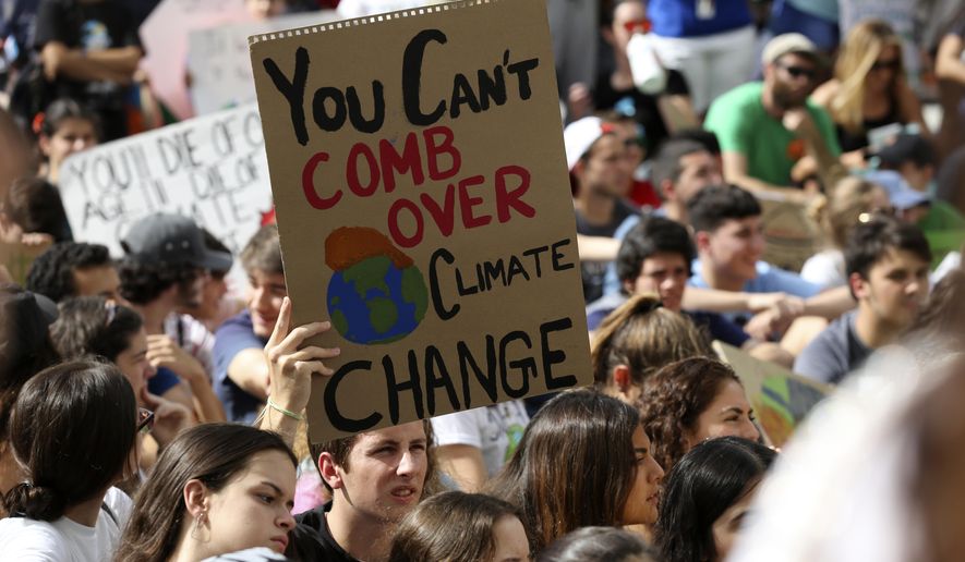 A student holds a sign during a protest organized by the U.S. Youth Climate Strike outside of Miami Beach City Hall, as part of a global day of climate action, Friday, Sept. 20, 2019, in Miami Beach, Fla. (AP Photo/Lynne Sladky)