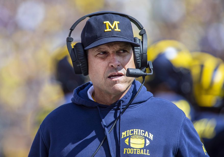 FILE - In this Saturday, Sept. 7, 2019. file photo,Michigan head coach Jim Harbaugh wears his headset on the sidelines in the first quarter of an NCAA football game against Army in Ann Arbor, Mich. Michigan is heading into the first really big Big Ten game of the season. The Wolverines face No. 13 Wisconsin in Madison on Saturday, Sept. 21, 2019. (AP Photo/Tony Ding, File)