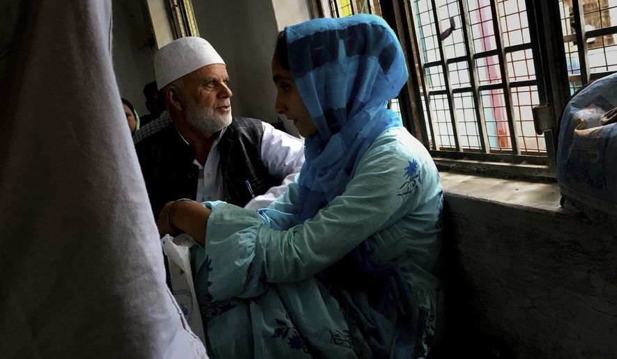 A Kashmiri family awaits their turn to meet a relative in Agra Central Jail in Agra, India, Friday, Sept. 20, 2019. Families from the Himalayan region of Kashmir have traveled nearly 1,000 kilometers (600 miles) in sweltering heat to meet relatives being held in an Indian jail in the city of Agra. At least 4,000 people, mostly young men, have been arrested in Indian-held Kashmir since the government of Prime Minister Narendra Modi imposed a security clampdown and scrapped the region’s semi-autonomy on Aug. 5, according to police officials and records reviewed by AP. (AP Photo/Altaf Qadri)