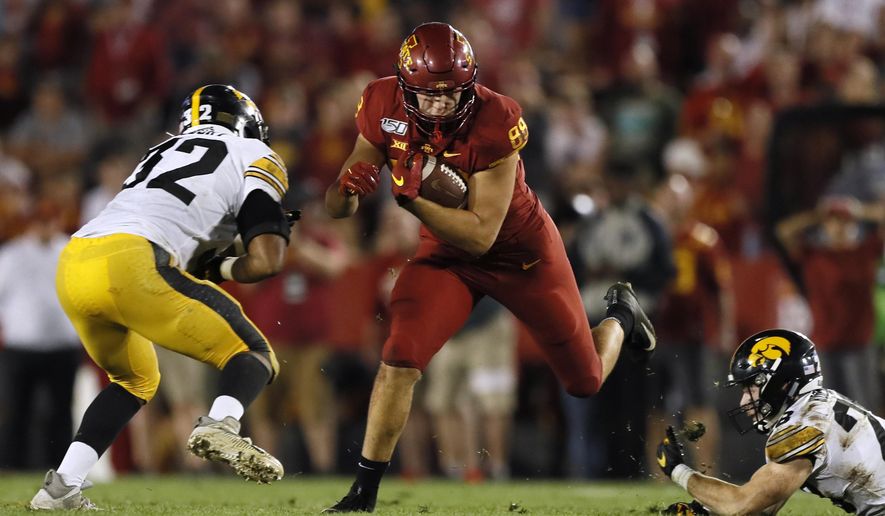 Iowa State tight end Charlie Kolar catches a pass between Iowa defenders Djimon Colbert, left, and Jack Koerner during the second half of an NCAA college football game Saturday, Sept. 14, 2019, in Ames, Iowa. Iowa won 18-17. (AP Photo/Charlie Neibergall)