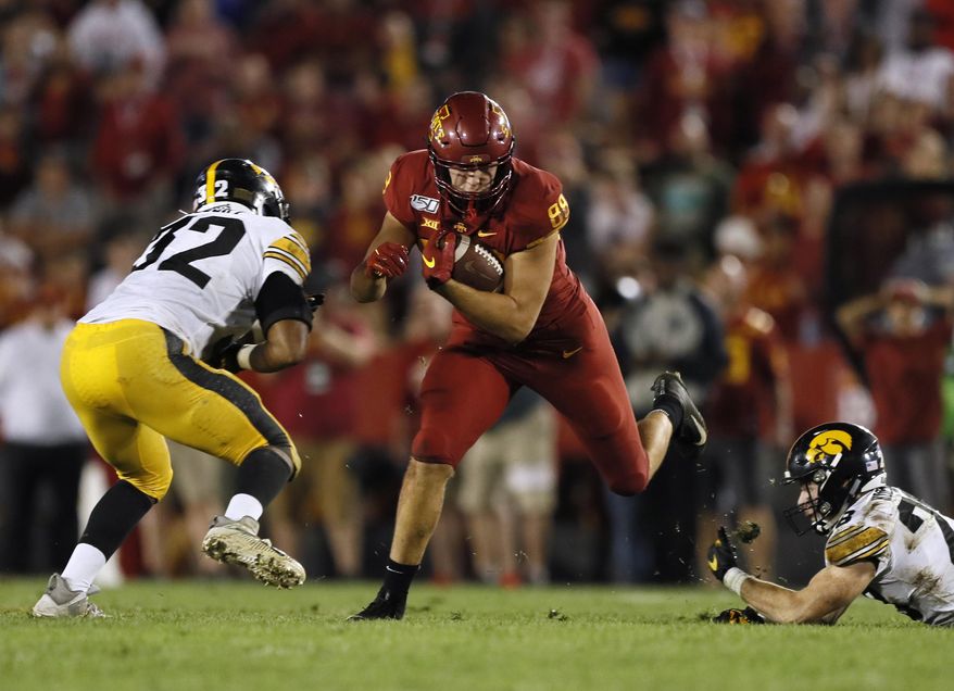 Iowa State tight end Charlie Kolar catches a pass between Iowa defenders Djimon Colbert, left, and Jack Koerner during the second half of an NCAA college football game Saturday, Sept. 14, 2019, in Ames, Iowa. Iowa won 18-17. (AP Photo/Charlie Neibergall)