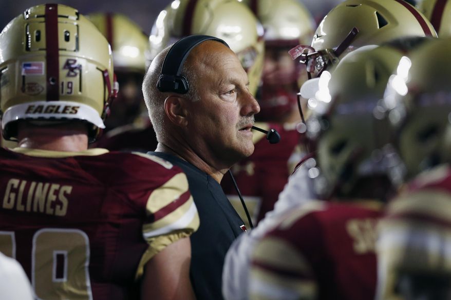Boston College head coach Steve Addazio stands with his team during a timeout in the first half of an NCAA college football game against Kansas in Boston, Friday, Sept. 13, 2019. (AP Photo/Michael Dwyer)