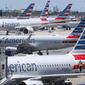 FILE - In this April 24, 2019, photo, American Airlines aircraft are shown parked at their gates at Miami International Airport in Miami. A former American Airlines mechanic who prosecutors say may have some links to terrorists is due to enter a plea to charges that he sabotaged an aircraft with 150 people aboard. An arraignment hearing is set Friday, Sept. 20, 2019, for 60-year-old Abdul-Majeed Marouf Ahmed Alani in Miami federal court. (AP Photo/Wilfredo Lee, File)