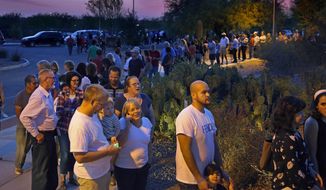 FILE - In this March 22, 2016, file photo, people wait in line to vote in a primary election in Chandler, Ariz. A group of independents is making a longshot push to convince the Arizona Democratic Party to open its presidential primary to voters who decline to join a political party. Party activists are expected to debate the issue at a meeting in Prescott on Saturday, Sept. 21, 2019. (David Kadlubowski/The Arizona Republic via AP, File)