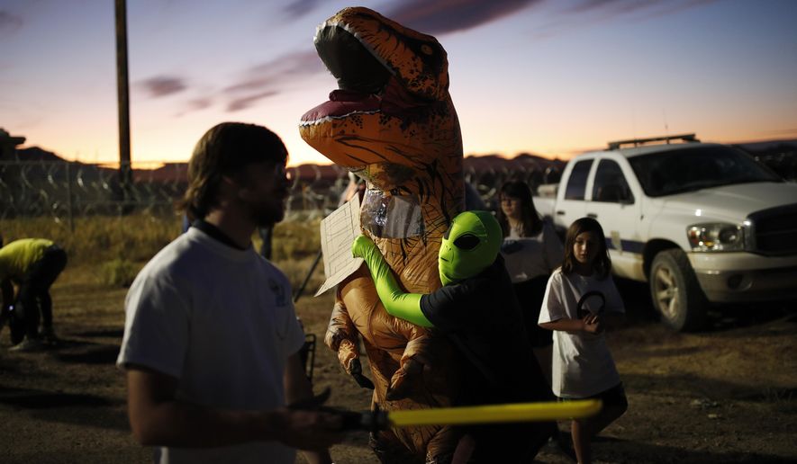 People dressed in costumes visit an entrance to the Nevada Test and Training Range near Area 51, Friday, Sept. 20, 2019, near Rachel, Nev. People came to visit the gate inspired by the &amp;quot;Storm Area 51&amp;quot; internet hoax. (AP Photo/John Locher)
