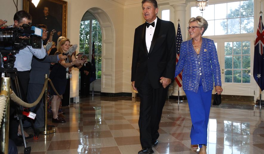 Sen. Joe Manchin, D-W.Va., left, and wife Gayle Conelly Manchin arrive for a State Dinner with Australian Prime Minister Scott Morrison and President Donald Trump at the White House, Friday, Sept. 20, 2019, in Washington. (AP Photo/Patrick Semansky)