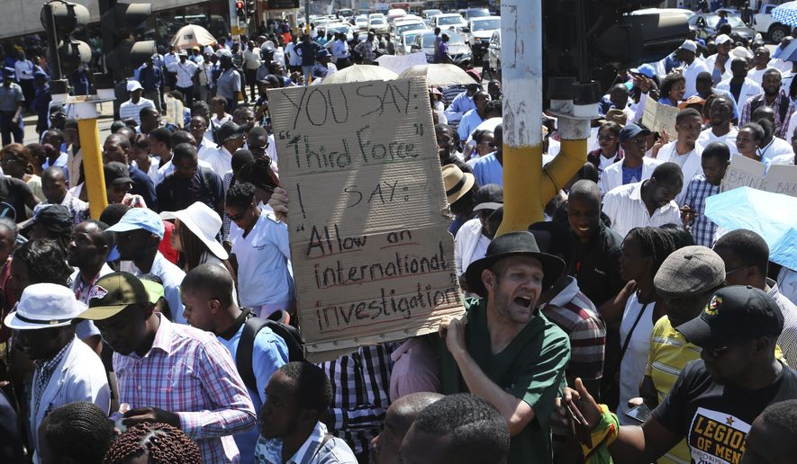 Zimbabewean medical staff march on the streets of Harare, Thursday, Sept. 19, 2019. Zimbabwean doctors protesting the alleged abduction of a union leader won a High court ruling allowing them to march and handover a petition to the parliament.The Zimbabwe Hospital Doctors Association has said its president, Peter Magombeyi, was abducted on Saturday after calling for a pay strike, and members say they will not return to work until he is found. (AP Photo/Tsvangirayi Mukwazhi)