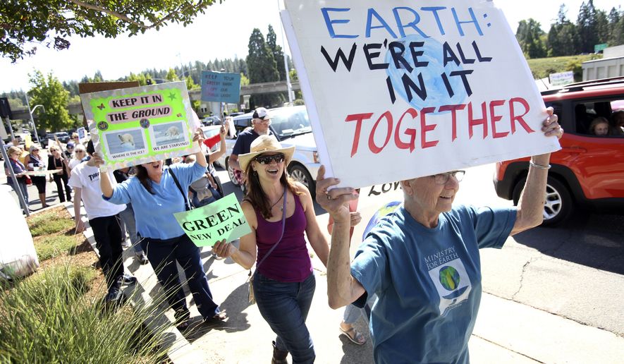 Hundreds of climate activists took to the streets of downtown Grass Valley, Calif., during Friday's global climate strike. People took part in world-wide protests of government inaction on climate change before the the U.N. Climate Action Summit on Monday. (Elias Funez/The Union via AP)