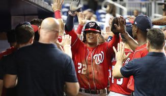 Washington Nationals&#39; Juan Soto (22) is congratulated by teammates after he, Adam Eaton and Anthony Rendon scored on a double by Kurt Suzuki during the 10th inning of a baseball game against the Miami Marlins, Saturday, Sept. 21, 2019, in Miami. The Nationals defeated the Marlins 10-4 in 10 innings. (AP Photo/Wilfredo Lee) ** FILE **