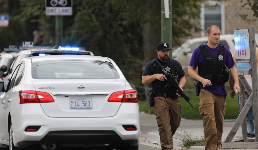 Police search for a suspect that shot a Chicago Police Department officer, near 63rd and Damen, Saturday, Sept. 21, 2019. The shooting happened around 8:40 a.m. (Abel Uribe/Chicago Tribune via AP)