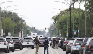 Police search for a suspect who shot a Chicago Police Department officer, near 63rd and Damen, Saturday, Sept. 21, 2019. The shooting happened around 8:40 a.m. (Abel Uribe/Chicago Tribune via AP)