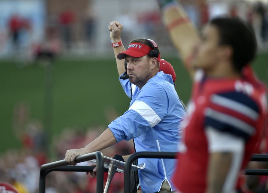 Liberty coach Hugh Freeze celebrates after a touchdown against Hampton during a college football game in Lynchburg, Va., Saturday, Sept. 21, 2019. (Taylor Irby/The News & Advance via AP)
