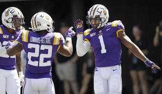 LSU wide receiver Ja&#39;Marr Chase (1) celebrates with running back Clyde Edwards-Helaire (22) after Chase scored a touchdown on a 51-yard pass play against Vanderbilt in the first half of an NCAA college football game Saturday, Sept. 21, 2019, in Nashville, Tenn. (AP Photo/Mark Humphrey)