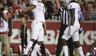 San Jose State receiver Isaiah Holiness (1) celebrates with teammate Jermaine Braddock after scoring a touchdown against Arkansas during the first half of an NCAA college football game, Saturday, Sept. 21, 2019 in Fayetteville, Ark. (AP Photo/Michael Woods)