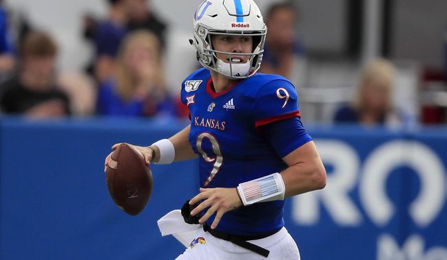 Kansas quarterback Carter Stanley looks for a receiver during the first half of an NCAA college football game against West Virginia in Lawrence, Kan., Saturday, Sept. 21, 2019. (AP Photo/Orlin Wagner)