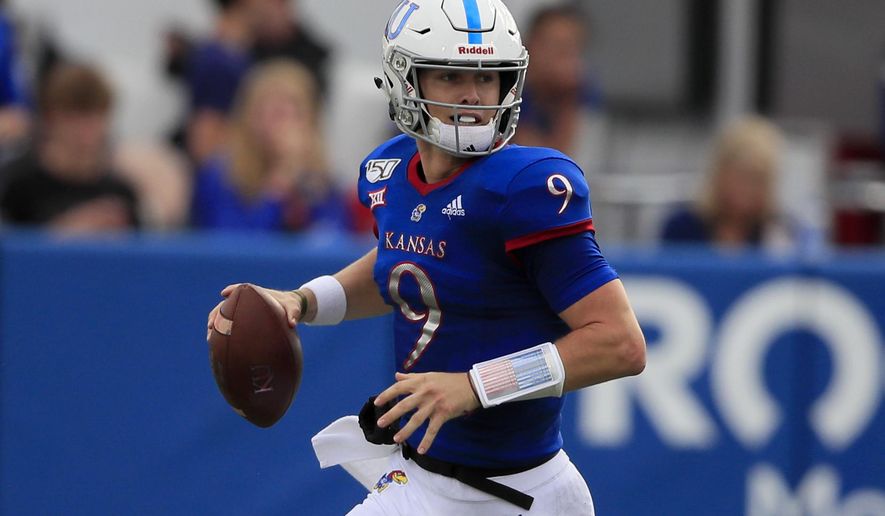 Kansas quarterback Carter Stanley looks for a receiver during the first half of an NCAA college football game against West Virginia in Lawrence, Kan., Saturday, Sept. 21, 2019. (AP Photo/Orlin Wagner)