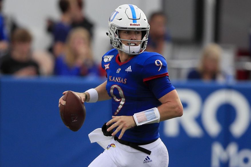Kansas quarterback Carter Stanley looks for a receiver during the first half of an NCAA college football game against West Virginia in Lawrence, Kan., Saturday, Sept. 21, 2019. (AP Photo/Orlin Wagner)
