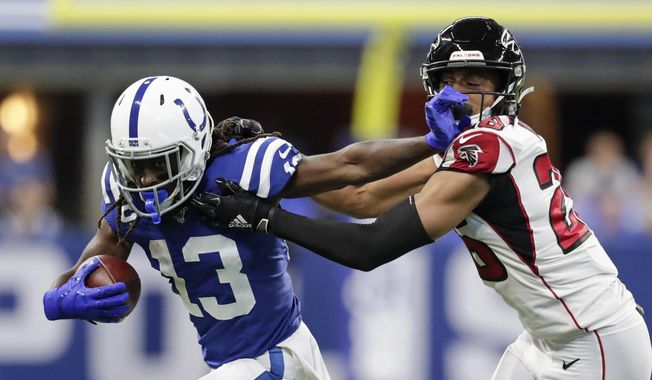 Indianapolis Colts wide receiver T.Y. Hilton (13) is tackled by Atlanta Falcons cornerback Isaiah Oliver (26) during the first half of an NFL football game, Sunday, Sept. 22, 2019, in Indianapolis. (AP Photo/Michael Conroy)