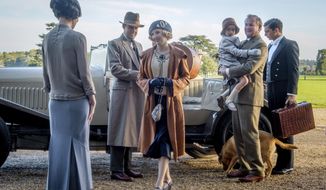 This image released by Focus Features shows Elizabeth McGovern, from left, Harry Hadden-Paton, Laura Carmichael, Hugh Bonneville and Michael Fox, right, in a scene from the film &amp;quot;Downton Abbey.&amp;quot; (Jaap Buitendijk/Focus Features via AP)