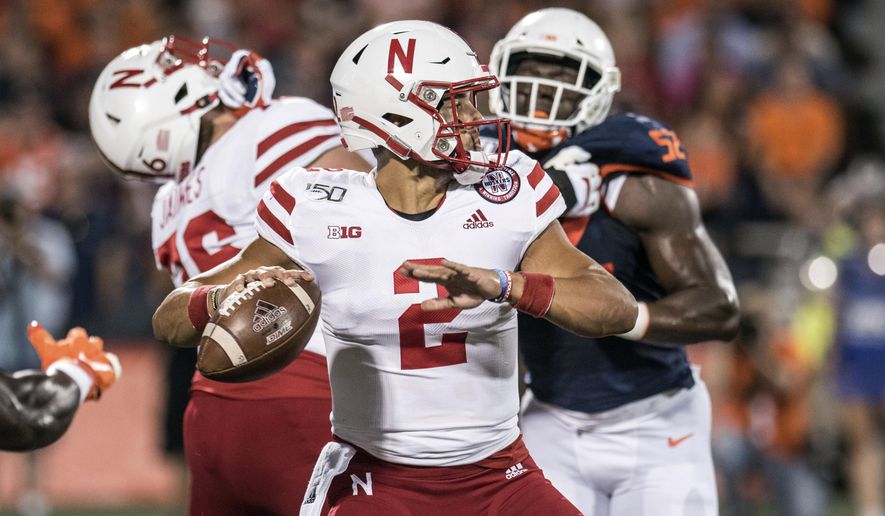 Nebraska quarterback Adrian Martinez (2) passes in the first half of an NCAA college football game against Illinois, Saturday, Sept. 21, 2019, in Champaign, Ill. (AP Photo/Holly Hart)