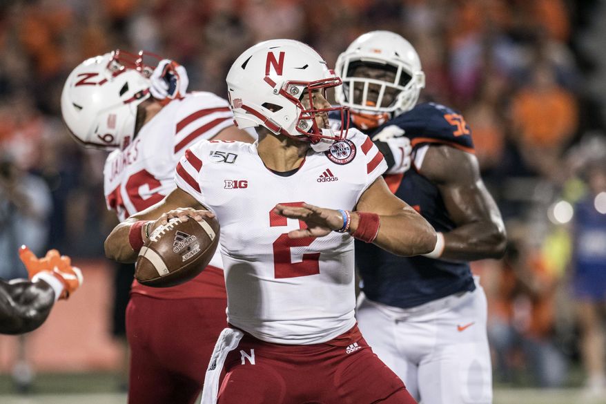 Nebraska quarterback Adrian Martinez (2) passes in the first half of an NCAA college football game against Illinois, Saturday, Sept. 21, 2019, in Champaign, Ill. (AP Photo/Holly Hart)