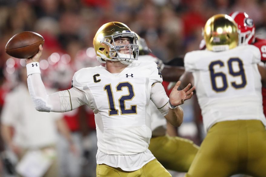 Notre Dame quarterback Ian Book (12) works in the pocket against Georgia during the first half of an NCAA college football game, Saturday, Sept. 21, 2019, in Athens, Ga. (AP Photo/John Bazemore)