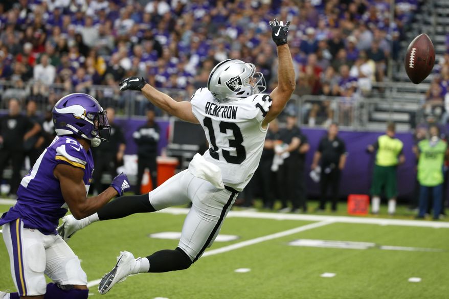 Minnesota Vikings cornerback Mike Hughes, left, breaks up a pass intended for Oakland Raiders wide receiver Hunter Renfrow (13) during the second half of an NFL football game, Sunday, Sept. 22, 2019, in Minneapolis. (AP Photo/Bruce Kluckhohn)