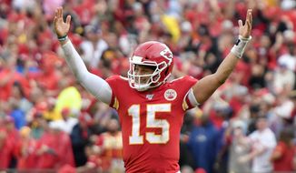 Kansas City Chiefs quarterback Patrick Mahomes (15) celebrates a touchdown by running back Darwin Thompson during the second half of an NFL football game against the Baltimore Ravens in Kansas City, Mo., Sunday, Sept. 22, 2019. (AP Photo/Ed Zurga)