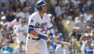 Los Angeles Dodgers&#39; Cody Bellinger watches his grand slam against the Colorado Rockies during the fifth inning of a baseball game in Los Angeles, Sunday, Sept. 22, 2019. (AP Photo/Sam Gangwer )