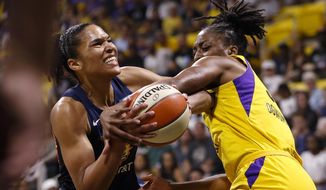 Connecticut Sun&#39;s Alyssa Thomas, left, is fouled by Los Angeles Sparks&#39; Nneka Ogwumike during the first half of Game 3 of a WNBA basketball playoff game Sunday, Sept. 22, 2019, in Long Beach, Calf. (AP Photo/Ringo H.W. Chiu)
