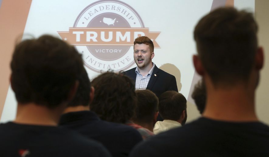 Rylee Cupp, University of Akron's College Republican president welcomes students from area colleges and universities at the start of a Trump Victory voter registration training at the UA's Student Union in Akron, Ohio, on Monday, Sept. 16, 2019. The Republican National Committee and President Donald Trump's re-election campaign are rolling out an effort to register young voters and mobilize supporters on college campuses. The "Make Campus Great Again" initiative puts a college twist on their grassroots voter registration effort, offering dozens of participants free pizza and training, plus swag like campaign buttons and drink insulators to distribute. It started at four schools in Ohio last week. Organizers describe it as a national effort, with similar swing state trainings held or planned for the University of Wisconsin-Madison, the University of Denver and Michigan college Republicans. (Mike Cardew, Beacon Journal/Ohio.com via AP)