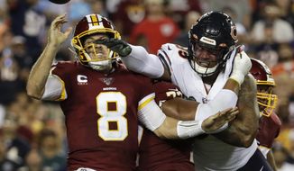 Chicago Bears outside linebacker Khalil Mack (52) hits Washington Redskins quarterback Case Keenum (8) to cause a fumble during the first half of an NFL football game Monday, Sept. 23, 2019, in Landover, Md. (AP Photo/Julio Cortez)  **FILE**