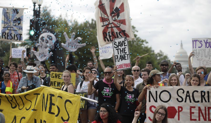 Protesters block traffic near the U.S. Capitol in Washington, Monday, Sept. 23, 2019. A broad coalition of climate and social justice organizations are disrupting the morning rush hour commute. (AP Photo/Pablo Martinez Monsivais)