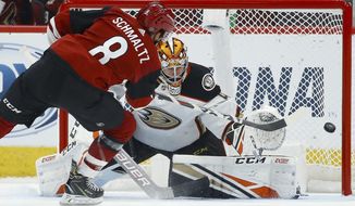 Arizona Coyotes center Nick Schmaltz (8) scores a goal against Anaheim Ducks goaltender Kevin Boyle, right, during the shootout in a preseason NHL hockey game Saturday, Sept. 21, 2019, in Glendale, Ariz. The Coyotes won 4-3. (AP Photo/Ross D. Franklin)