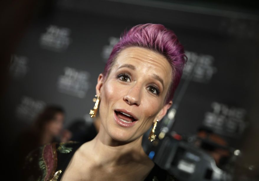 United States forward Megan Rapinoe arrives to attend the Best FIFA soccer awards, in Milan's La Scala theater, northern Italy, Monday, Sept. 23, 2019. Netherlands defender Virgil van Dijk is up against five-time winners Cristiano Ronaldo and Lionel Messi for the FIFA best player award and Rapinoe is the favorite for the women's award. (AP Photo/Luca Bruno)