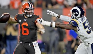 Cleveland Browns quarterback Baker Mayfield (6) looks to throw under pressure from Los Angeles Rams defensive end Dante Fowler during the first half of an NFL football game Sunday, Sept. 22, 2019, in Cleveland. (AP Photo/David Richard)