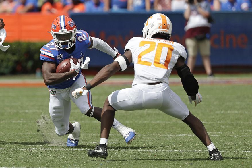 Florida running back Dameon Pierce (27) looks for room to get around Tennessee defensive back Bryce Thompson (20) during the second half of an NCAA college football game, Saturday, Sept. 21, 2019, in Gainesville, Fla. (AP Photo/John Raoux)