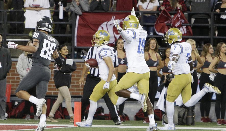 UCLA wide receiver Kyle Philips (2) returns a punt for a touchdown in front of teammates Alex Johnson (19), Mo Osling III (7) and Washington State wide receiver Rodrick Fisher (88) during the second half of an NCAA college football game in Pullman, Wash., Saturday, Sept. 21, 2019. UCLA won 67-63. (AP Photo/Young Kwak)